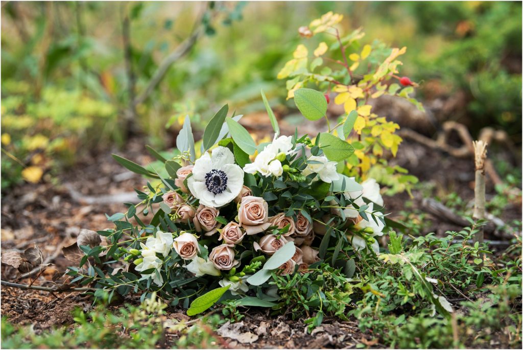 Natural bridal bouquet full of blush pink roses, white accents and greenery compliments forest wedding