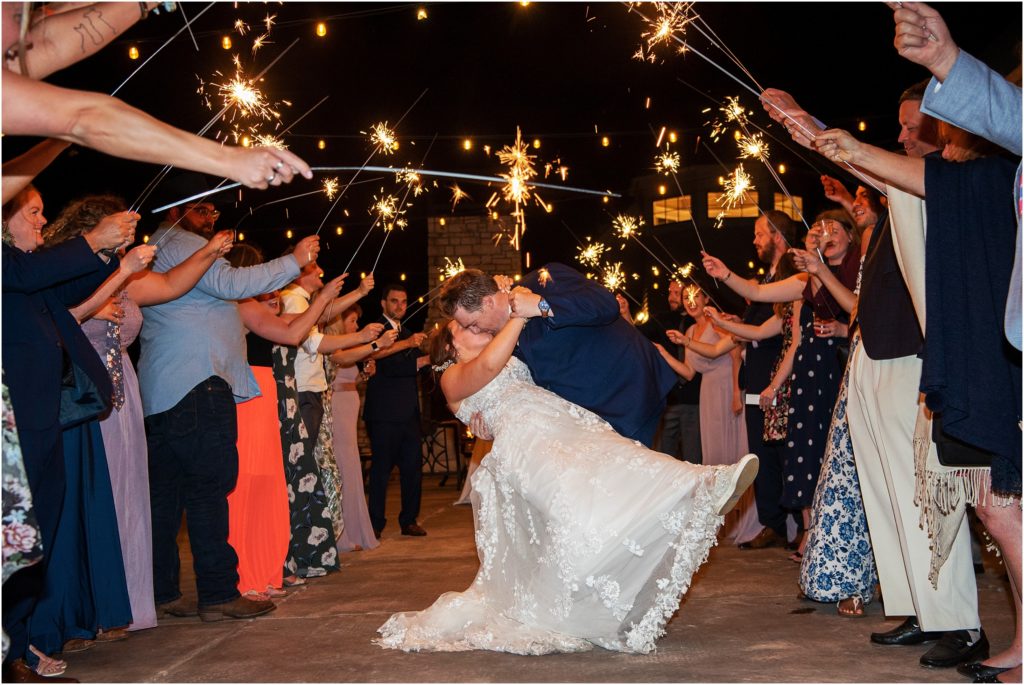 Wedding guests line up with sparklers to create a magical wedding sendoff