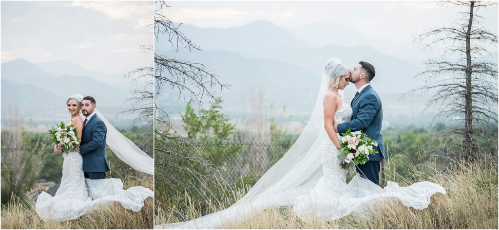 bride and groom standing in field with mountain views all around