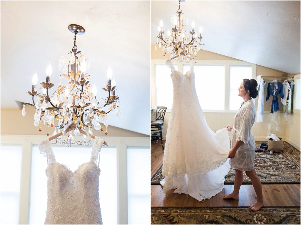 Bride looks at wedding dress as it hangs in the dressing room at Spruce Mountain Lodge