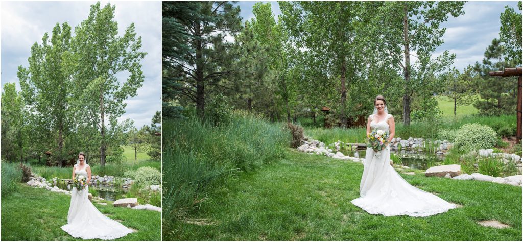 Bride stands in green grass with green trees all round at her summer wedding in Colorado