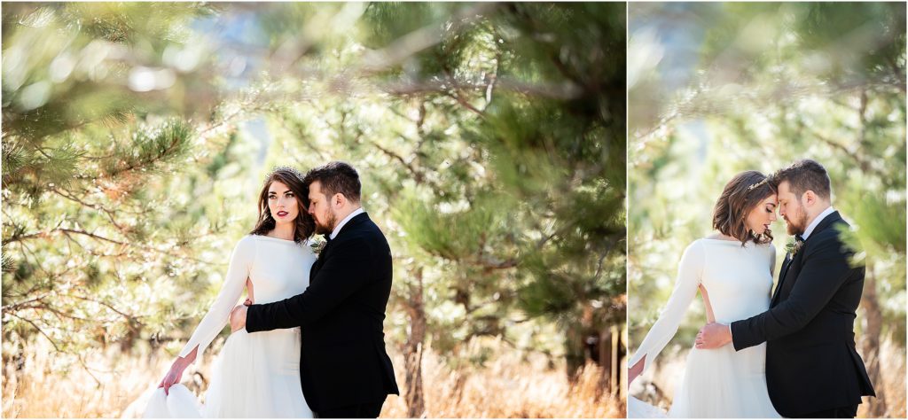 Bride and groom embrace while standing in a forested area on their wedding day in November