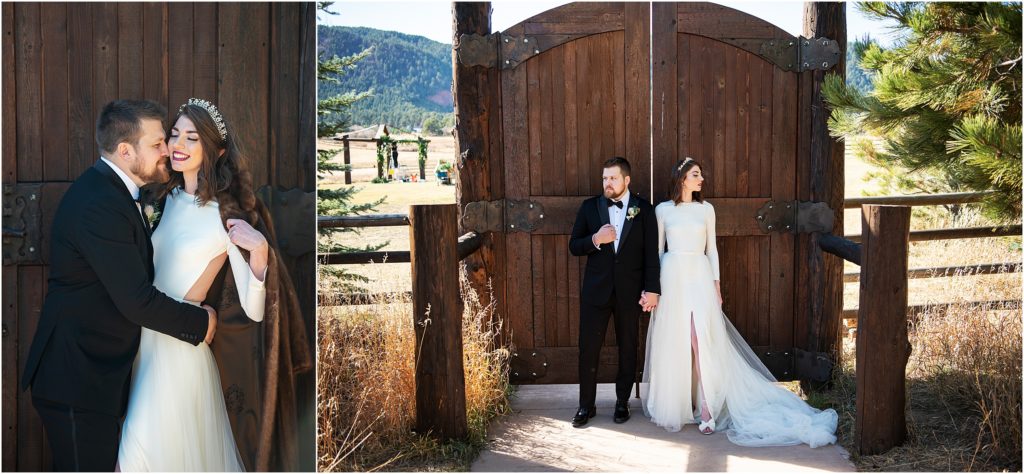 Bride and groom stand holding hands and embracing in front of large wooden doors