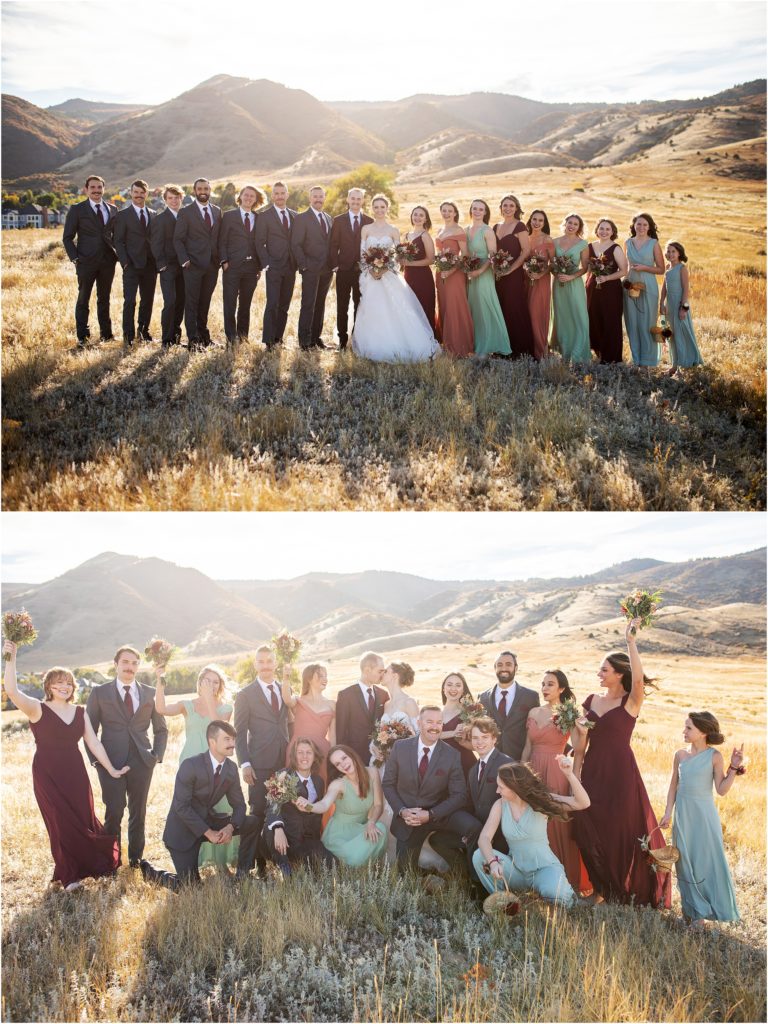 Bride and groom stand in the foothills of the Rocky Mountains with their large bridal party
