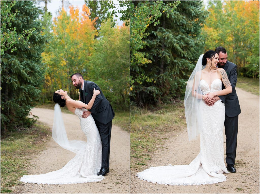 The couple stands together and embraces each other and laughs on their wedding day with stunning changing Aspen trees in the fall in Colorado