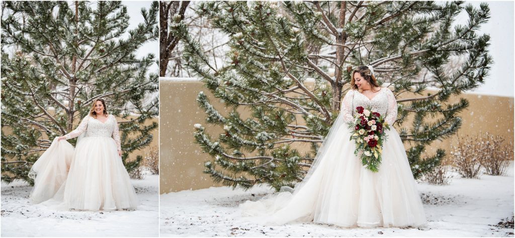Bride stands with snow falling all around at her dreamy winter wedding
