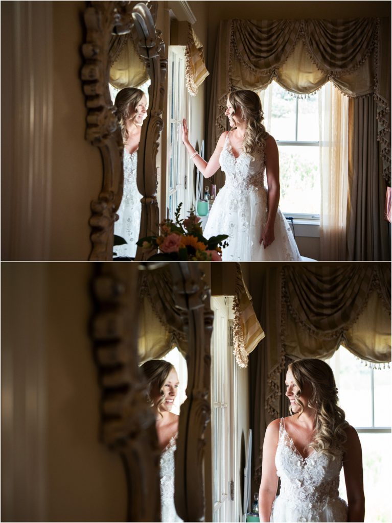 Bride stands in her wedding dress looking out the window on her wedding day