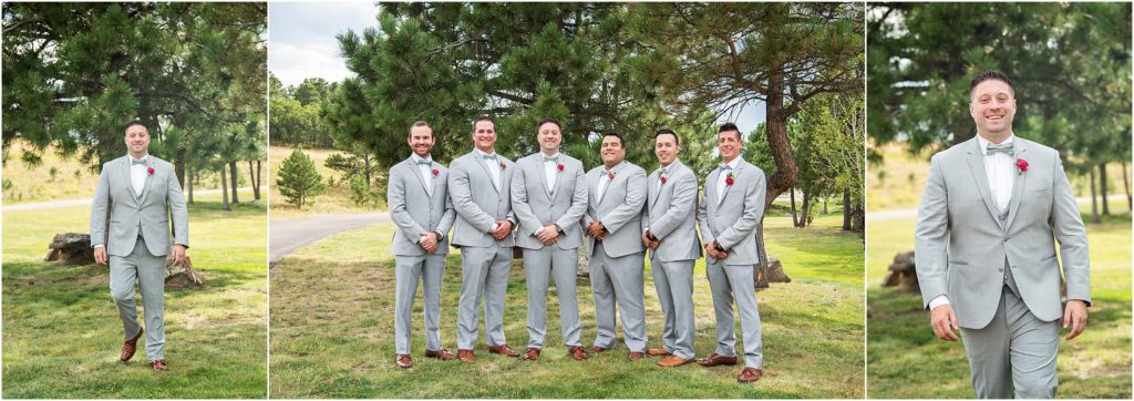 Groom stands with his five groomsmen who are wearing light grey suits and red boutonnieres