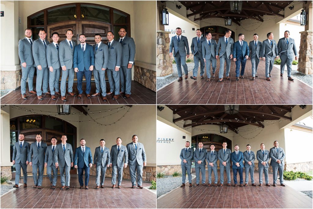 Groom and groomsmen stand and laugh and walk for photos in front of the wedding venue