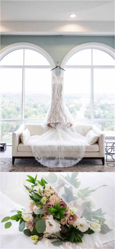 Wedding dress hangs in bridal suite between two large windows