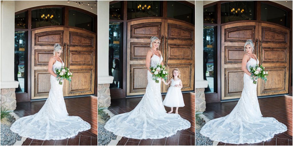 Bride and flower girl stand in front of the large doors at the Pinery for wedding photos